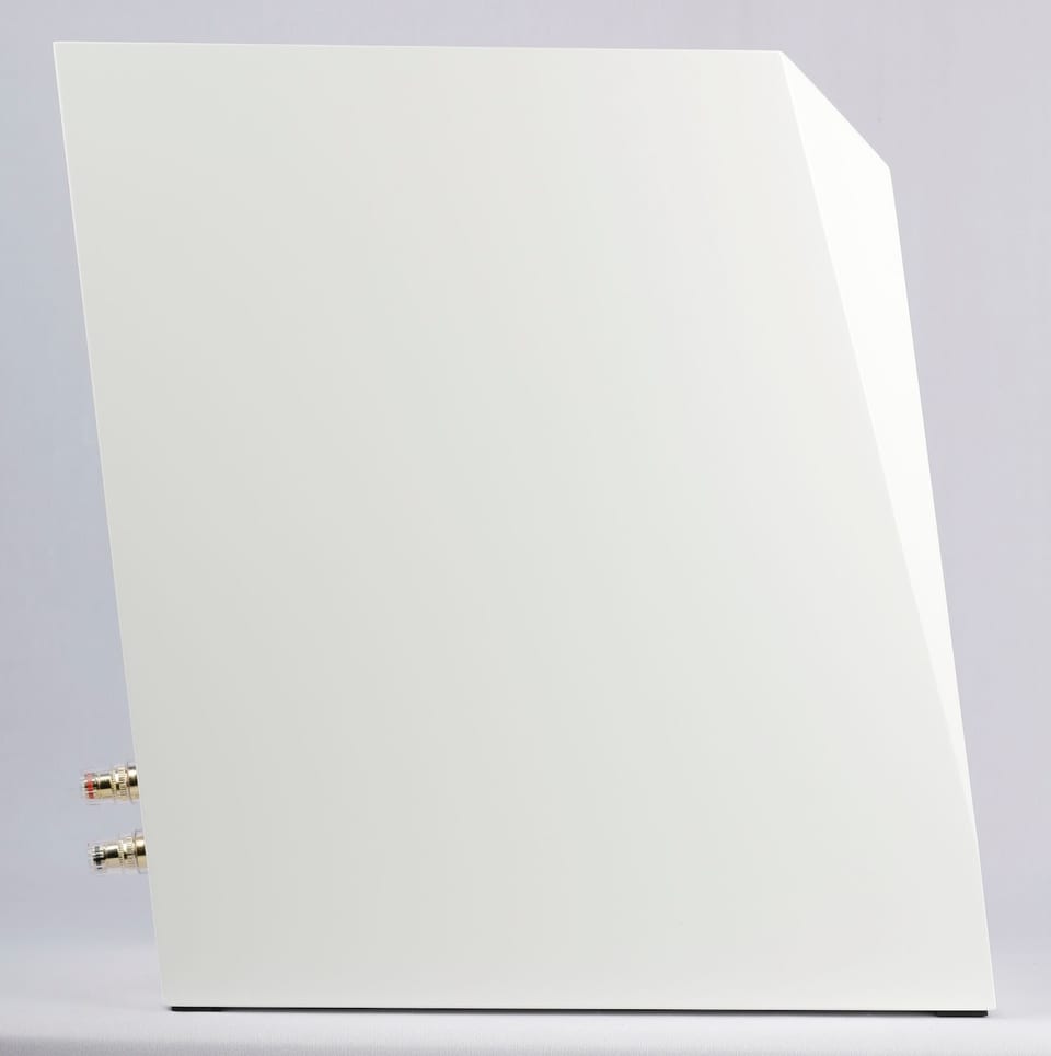 Ara Be bookshelf speaker side profile in gloss white, showing slanted cabinet, faceted top edge and rear binding posts.